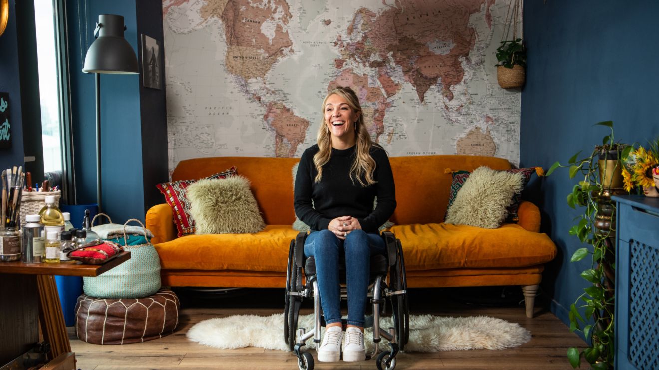 Sophie Morgan sits in her wheelchair in a living room.